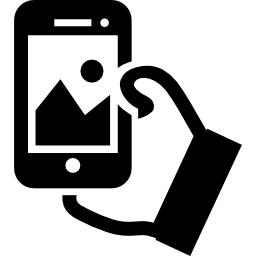 Hand holding cellphone to take a selfie icon