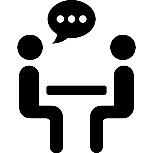 deux personnes discutant partage assis sur une table  Icône